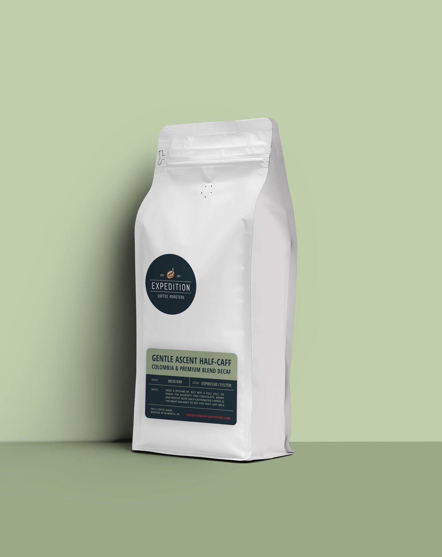 Gentle Ascent half-caff coffee beans in a white coffee bag with a label on a light green background